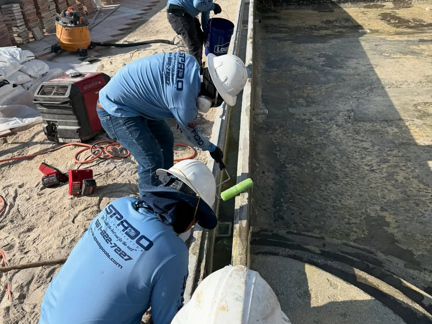 Spado Construction crew performing pool deck restoration work
