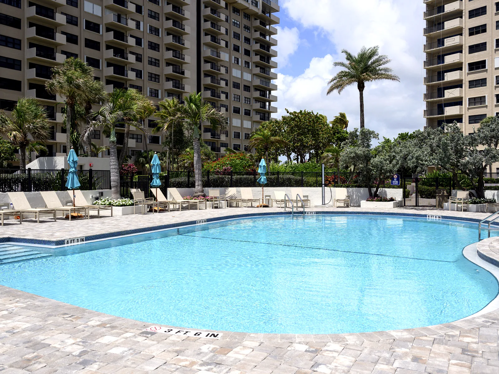 Completed Sea Ranch condominium pool renovation with pool, deck, and residential towers