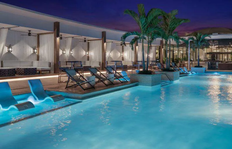 The Ben West Palm rooftop pool with cabanas and lounge seating