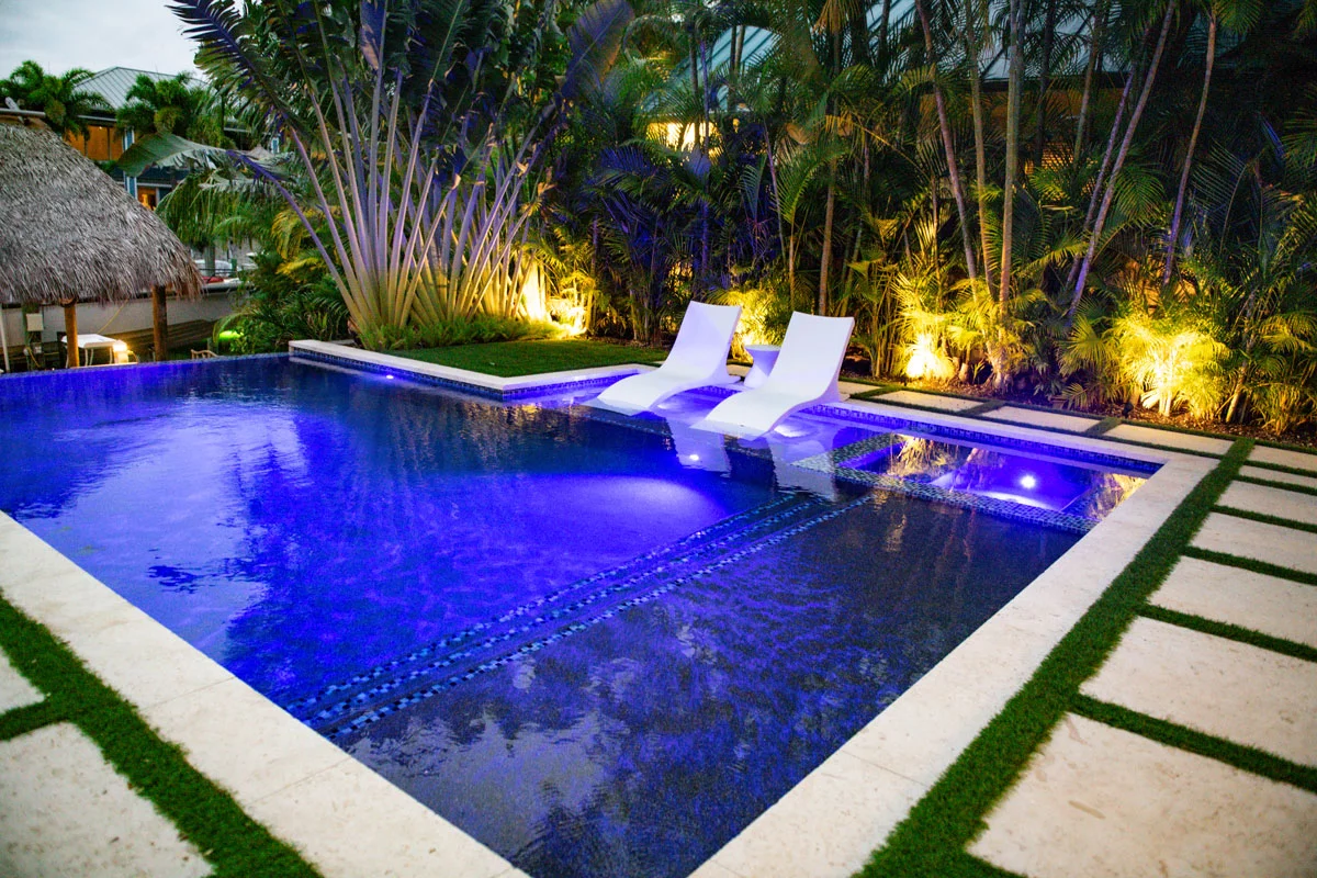 The Edge residential infinity pool with evening lighting